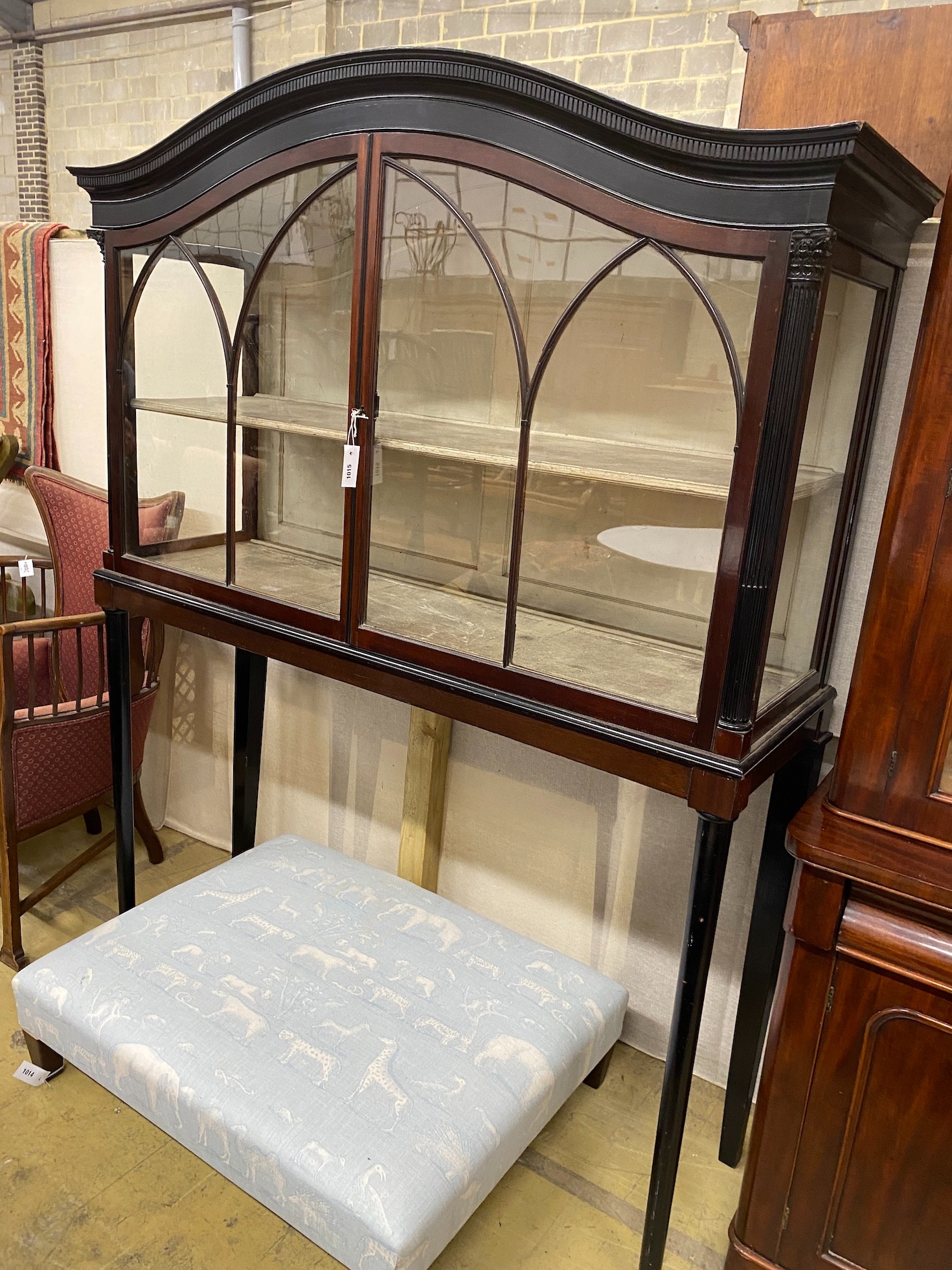 An Edwardian parcel ebonised mahogany museum cabinet with two glazed doors on slender turned tapered legs, width 154cm, height 202cm